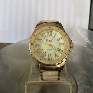 Working gold tone and brown watch